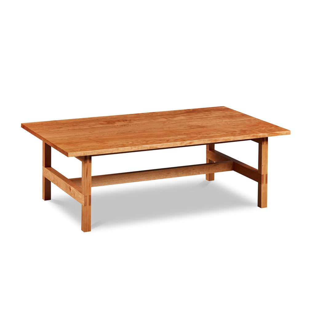 Modern rectangular trestle-style coffee table with visible joinery in cherry, from Maine's Chilton Furniture Co. 