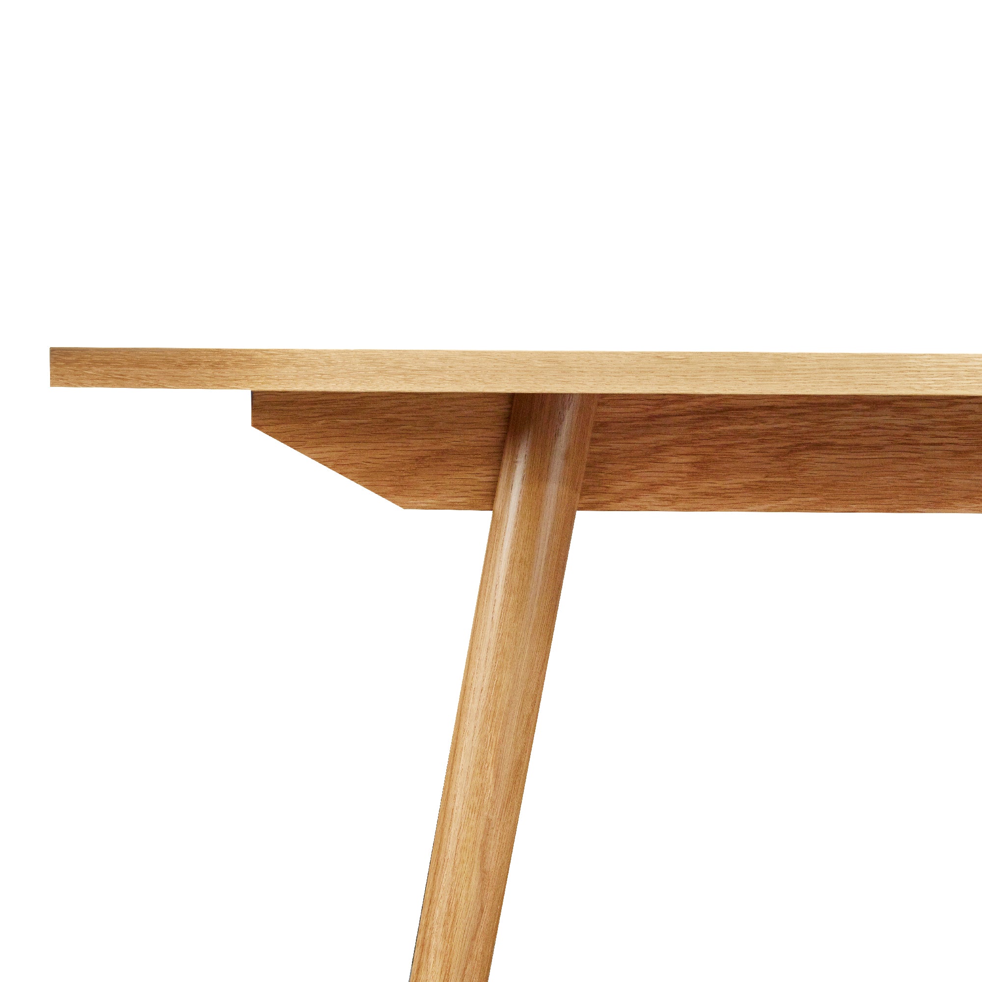 Detail of Mid-century modern Fjord dining table angled legs and apron in solid white oak from Chilton Furniture Co.