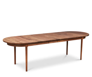 Modern solid walnut oval dining table with two leaves in