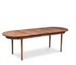 Modern solid walnut oval dining table with one leaf in