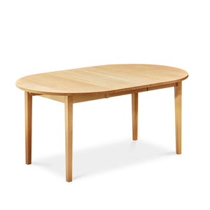 Solid maple wood extension table with one leaf with tapered Shaker legs and oval top from Maine's Chilton Furniture Co.