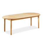 Fully extended solid maple wood table with tapered Shaker legs and oval top from Maine's Chilton Furniture Co.