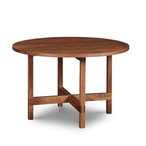 Modern round trestle table with visible joinery in walnut, from Maine's Chilton Furniture Co.