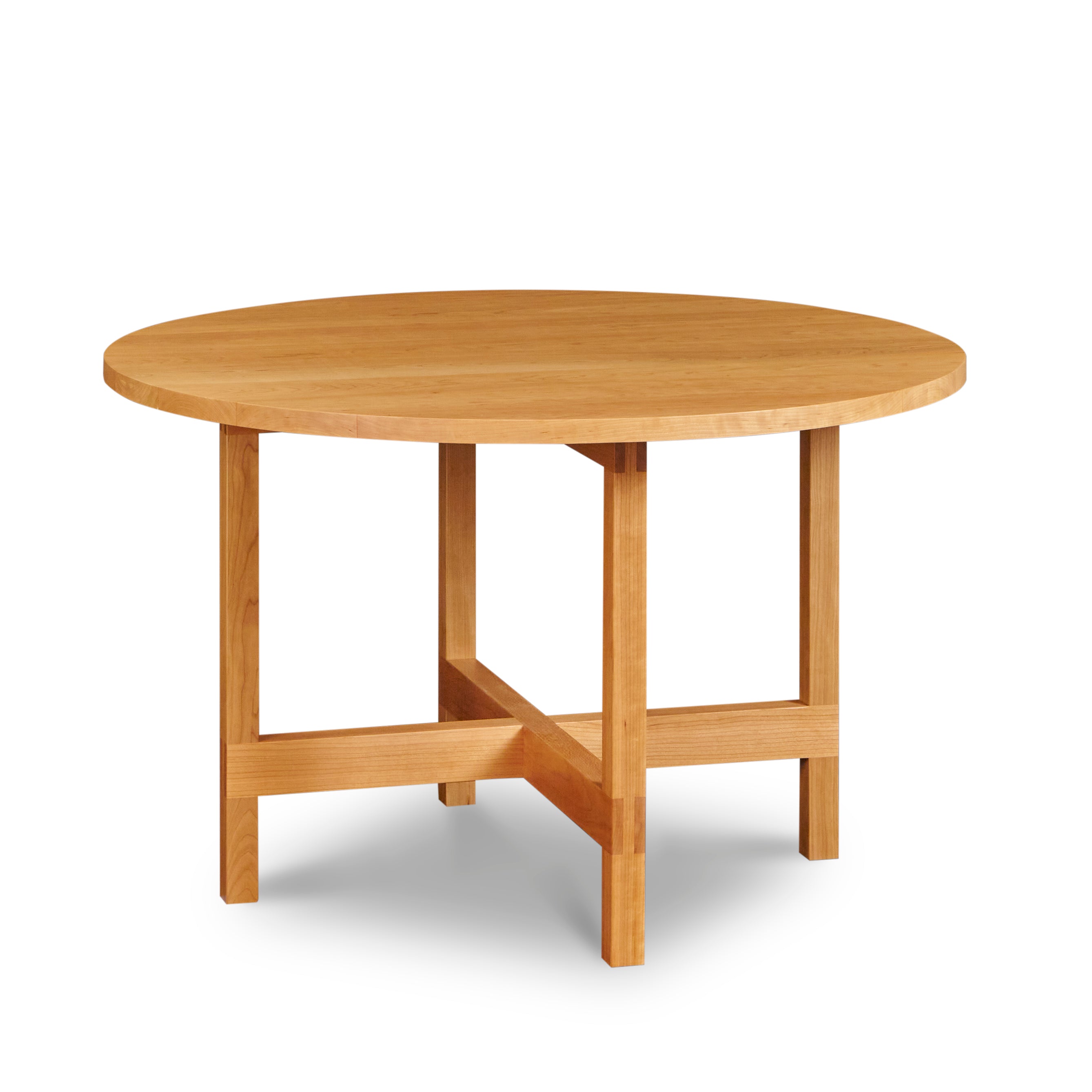 Modern round trestle table with visible joinery in cherry, from Maine's Chilton Furniture Co.