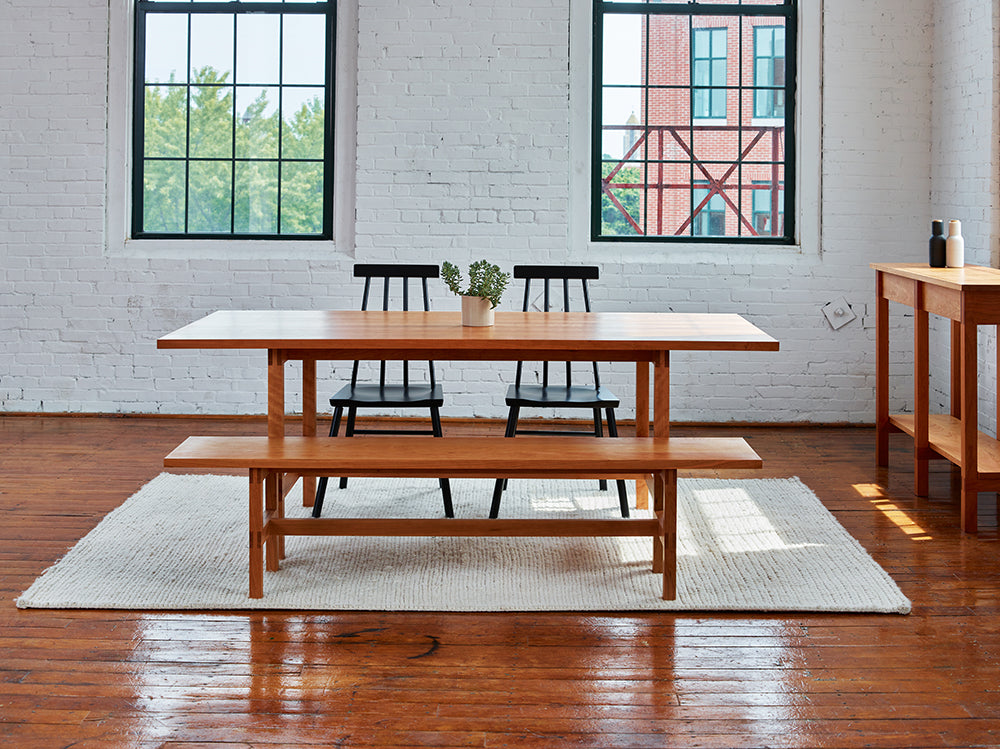 Warehouse loft dining room furnished with modern Union Table and Bench from Maine's Chilton Furniture Co.