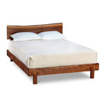 Modern low profile walnut bed with live edge headboard, from Maine's Chilton Furniture Co.