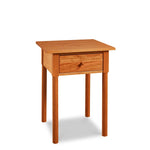 Modern interpretation of a classic Shaker style nightstand with one drawer and rounded legs, in solid cherry wood